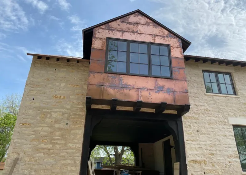 Copper metal panel facade on a stone building for Roof Repair in Burlingame